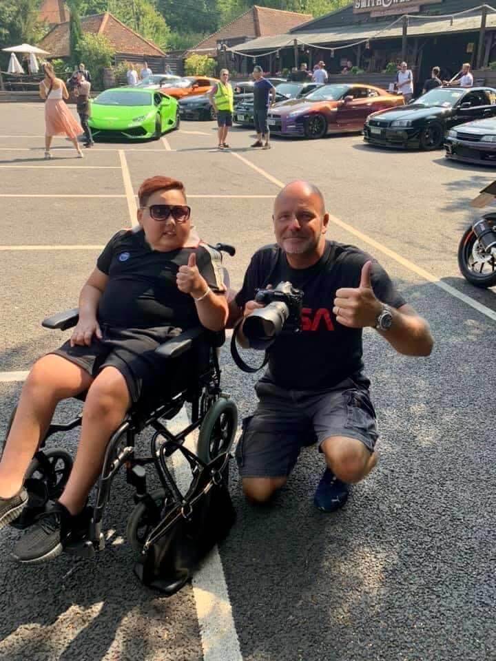 Michael O’Brien with wheelchair-bound 12-year-old boy, each with a thumbs-up pose.